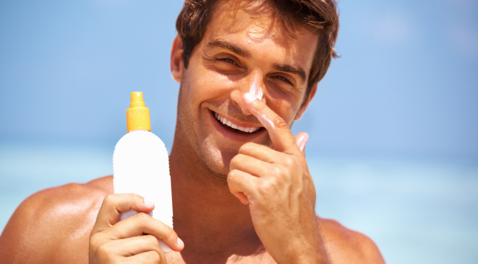 men apply sunscreen